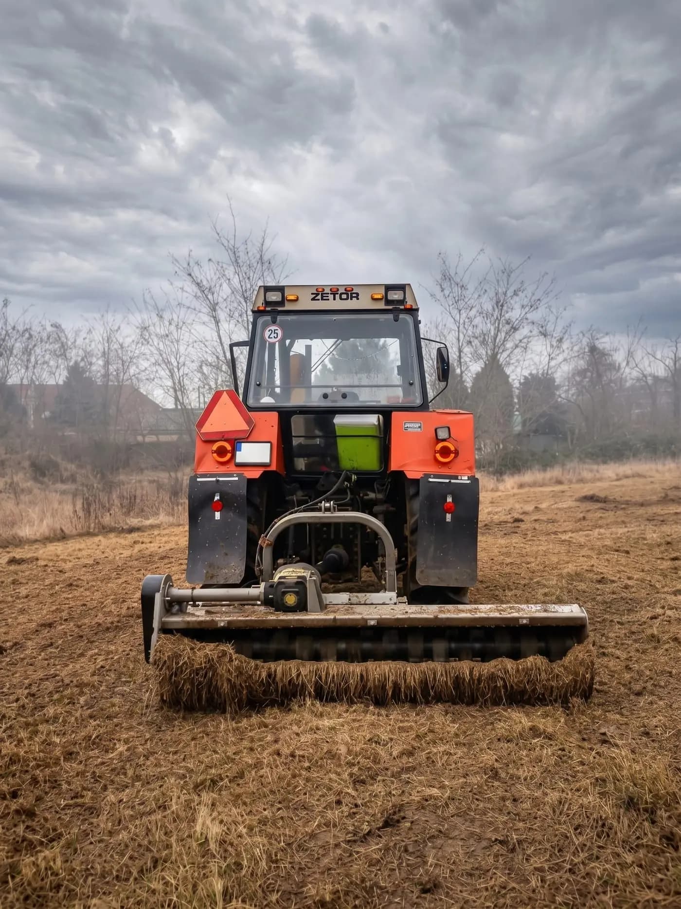 Traktor Zetor s mulčovacím zariadením pri údržbe väčšieho pozemku
